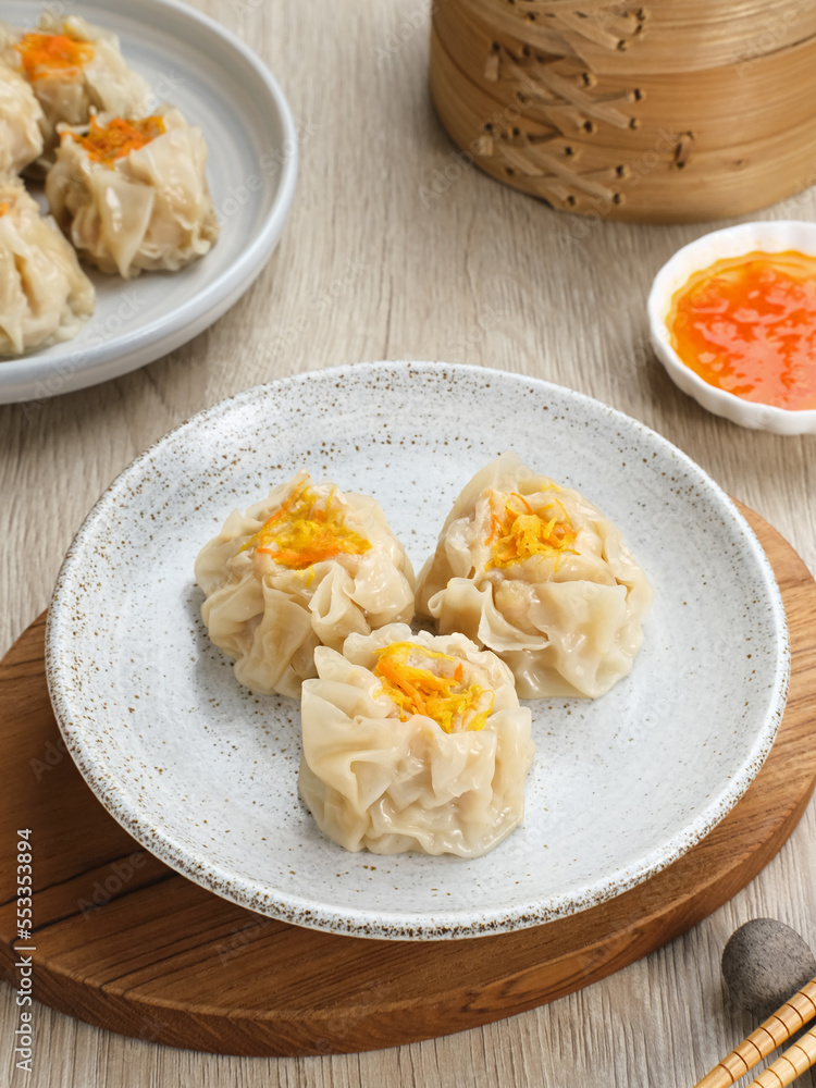 Steamed dumpling dimsum served in plate with chilli sauce Steamed dumpling dimsum served in plate with chilli sauce