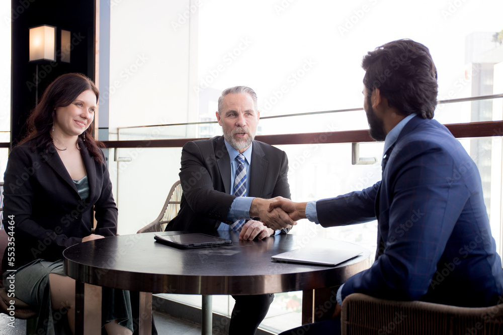 Senior executive or CEO and secretary talking and discussing for negotiation agreement and deal with partner about project together at office, business people meeting with consultant in team. Senior executive or CEO and secretary talking and discussing for negotiation agreement and deal with partner about project together at office, business people meeting with consultant in team.