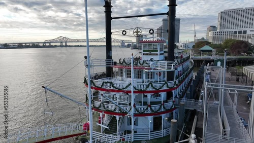 New Orleans Riverboat on Mississippi River in NOLA. Big Easy tourist attraction. Rising aerial of boat decorated at Christmas season.