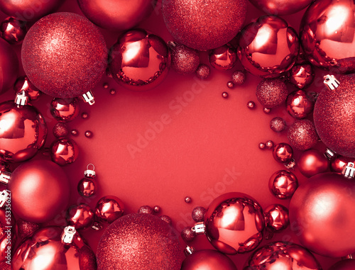 Creative Christmas concept made with Red Christmas baubles decoration on red luxurious background with copy space. .New Year greeting card. Minimal style. Flat lay.