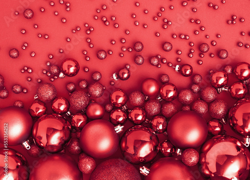 Creative Christmas concept made with Red Christmas baubles decoration on red luxurious background ..New Year greeting card. Minimal style. Flat lay.