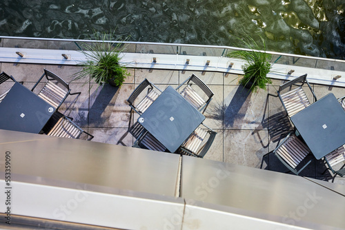 Looking down on dining patio tables next to water