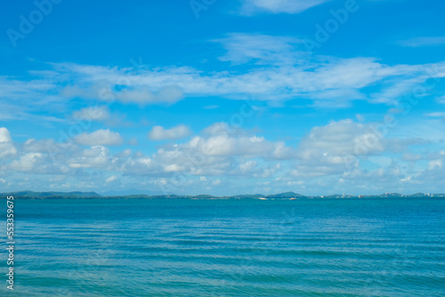 Tropical sea beach wave blue sky with fluffy cloud