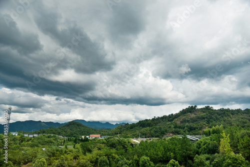 Dark sky storm cloudy greeen mountain landscape view © xy