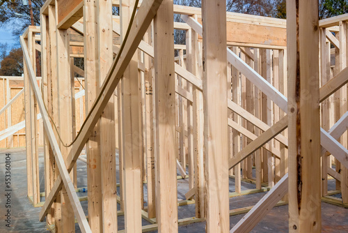 Wood framing beams of new house under construction in construction stage