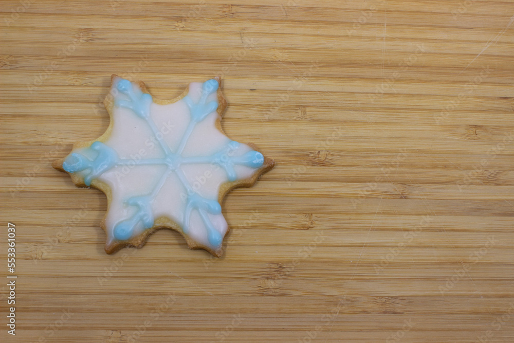 snowflake cutout cookie on a cutting board