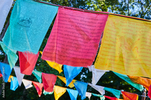 Rows of vibrant prayer flags for Tibetan Mongolian Buddhist shrine photo