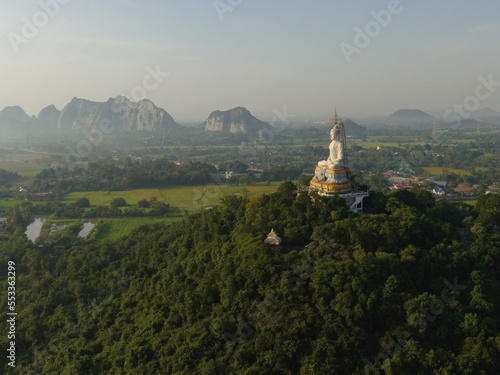 An aerial view of Big Buddha on the mountain stands prominently at Nong Hoi Temple in Ratchaburi near the Bangkok, Thailand. © Touchr