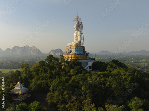 An aerial view of Big Buddha on the mountain stands prominently at Nong Hoi Temple in Ratchaburi near the Bangkok, Thailand.