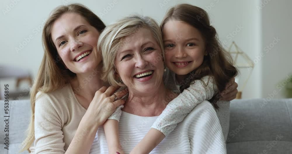 Older granny enjoy embraces and time with loving grown up daughter and granddaughter, close up view. Portrait of overjoyed multi generational family, understanding, harmonic relations, ties, affection