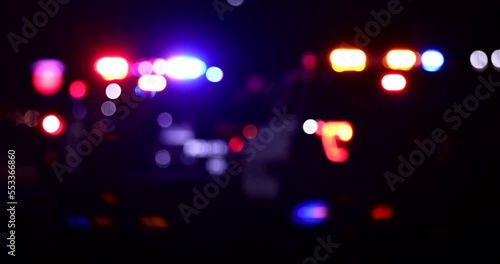 Abstracted night time bokeh view of police units responding to the scene of an emergency.