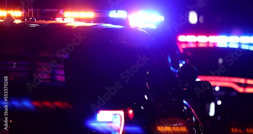 Night time view of a police unit responding to the scene of an emergency.