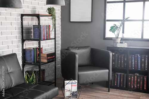 Shelf unit with books, sofa...