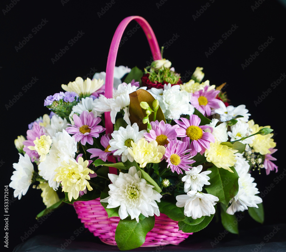 flowers in the basket on dark background