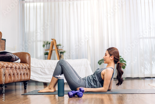 Portrait sport asian beauty body slim woman in sportswear sitting relax and girl practicing yoga and do fitness exercise in bedroom at home.Diet concept.Fitness and healthy