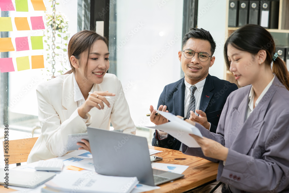 Group of asian business people working, discussing new projects together, having fun at the office. Group of asian business people working, discussing new projects together, having fun at the office.