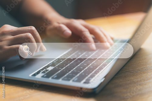Tableau sur toile Close up hand using laptop with search bar icon