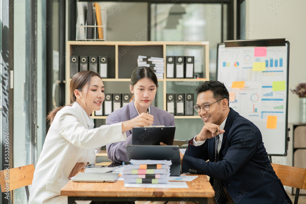 Group of asian business people working, discussing new projects together, having fun at the office. Group of asian business people working, discussing new projects together, having fun at the office.