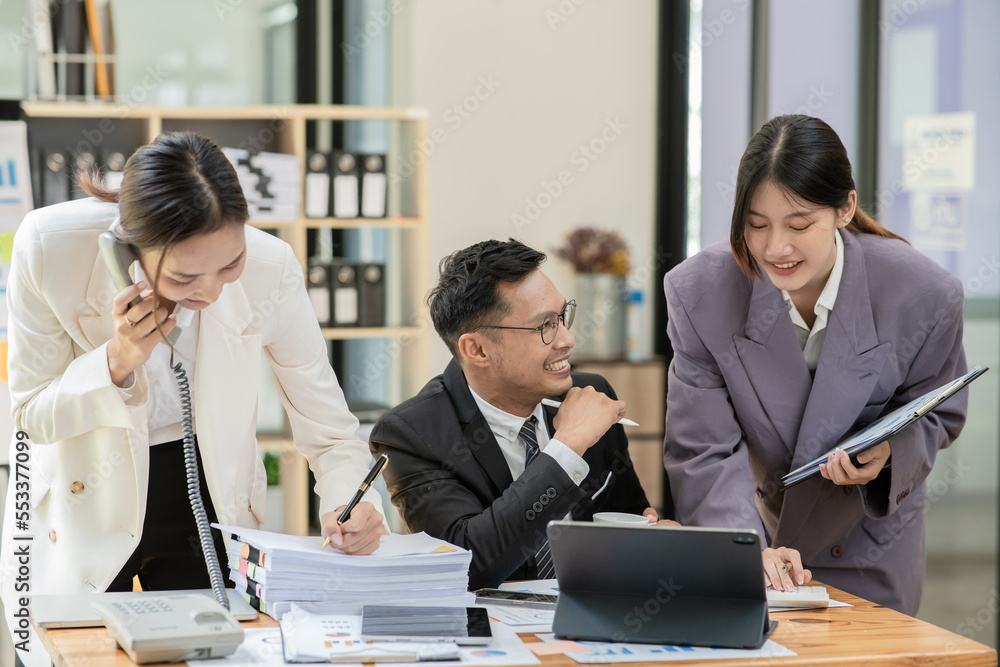 Group of asian business people working, discussing new projects together, having fun at the office. Group of asian business people working, discussing new projects together, having fun at the office.