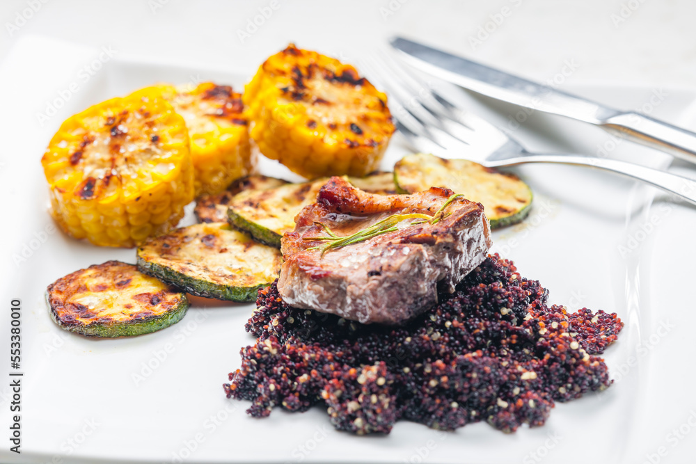 grilled pork steak with zucchini and corn served with black quinoa grilled pork steak with zucchini and corn served with black quinoa