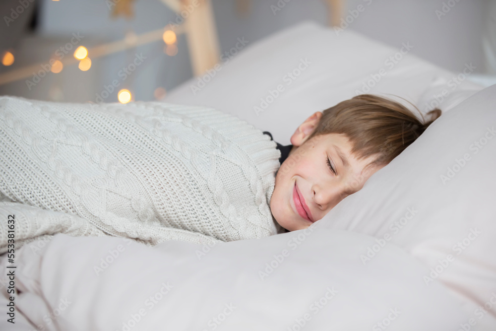 The little boy sleeps and smiles in his sleep, he has a good dream. The little boy sleeps and smiles in his sleep, he has a good dream.