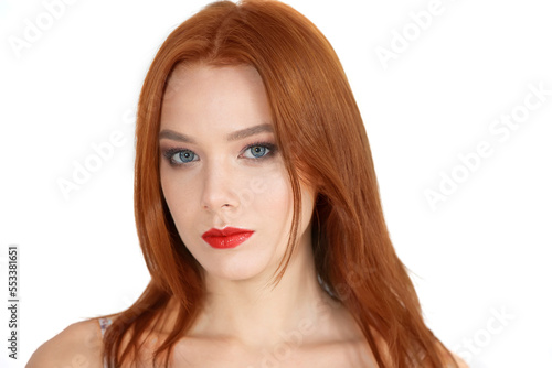 Portrait of a beautiful red-haired girl on a white background.