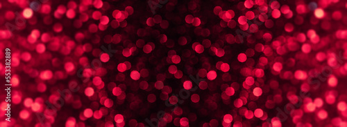 Festive red macro defocused glittering background. New Year and Christmas concept. Love and Valentin's day. magenta background. Viva magenta -Trendy color of 2023 year.