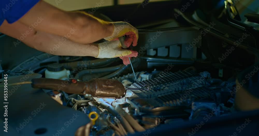 Male mechanic using wrench to repair the engine, car service Male mechanic using wrench to repair the engine, car service