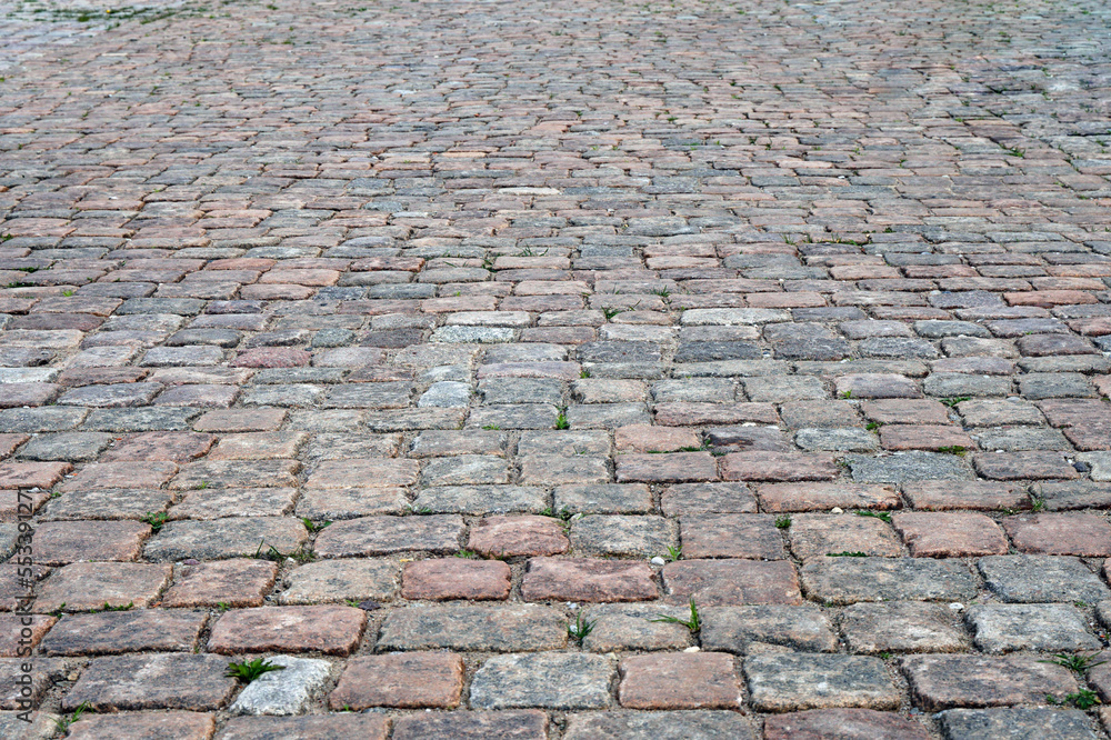 Stone pavement road. an old cobblestone sidewalk close-up.