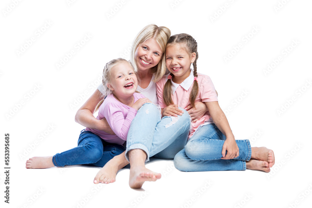 A young mother with her daughters smile and hug. Children with pigtails, in pink sweatshirts and jeans. Love and tenderness in a friendly family. Isolated on white background.
