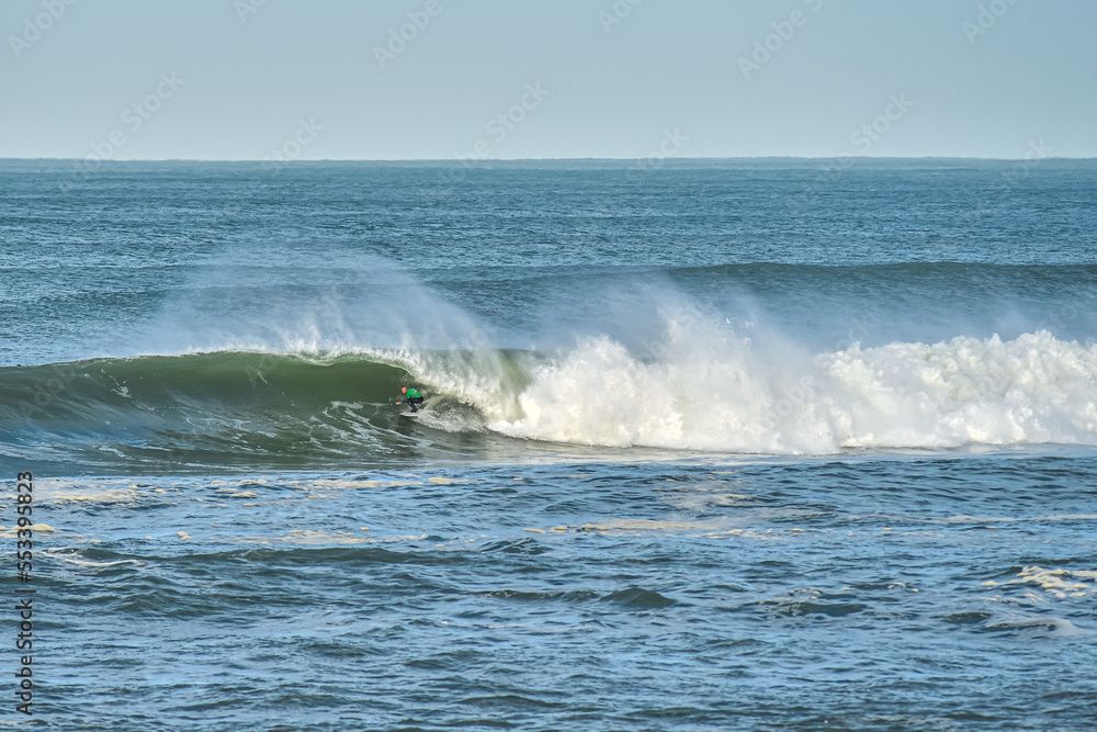 Big wave surfer in action on the north beach of Hossegor