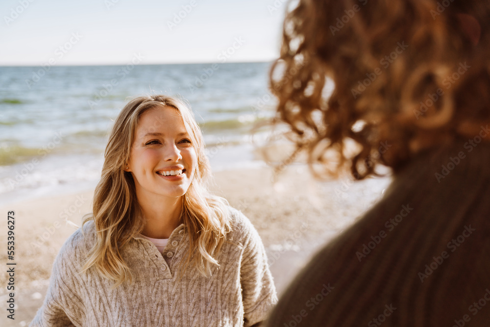 Beautiful woman spending time with her boyfriend at the beach Beautiful woman spending time with her boyfriend at the beach