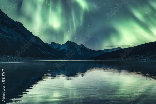 Scenery of Aurora borealis over Rocky Mountains in Medicine Lake at Jasper national park
