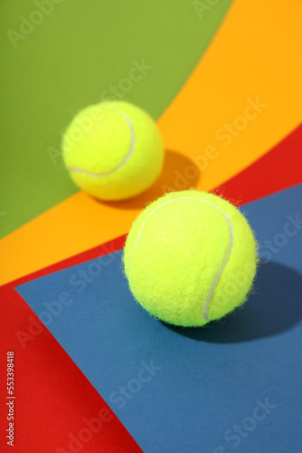 Two tennis balls on different colors background © Atlas