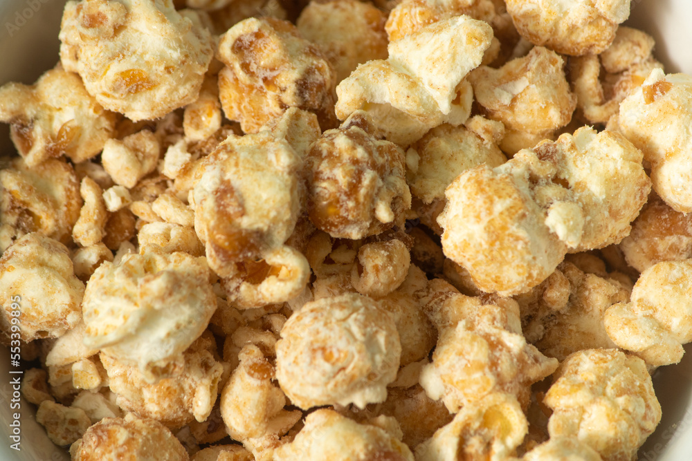 popcorn with butter caramel flavor on a white bowl and white background popcorn with butter caramel flavor on a white bowl and white background
