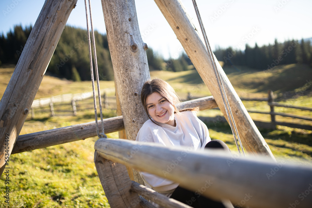 The girl rests in the mountains and enjoys life. A happy and smiling girl spends her weekend in the mountains. Rest and travel. The girl rests in the mountains and enjoys life. A happy and smiling girl spends her weekend in the mountains. Rest and travel.