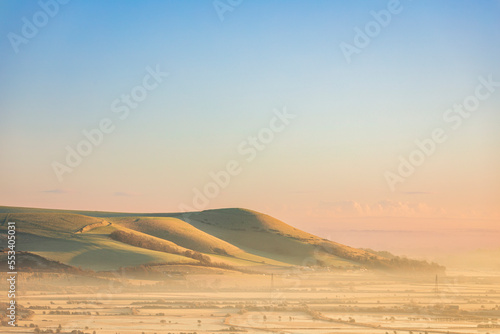 Mount Caburn rising from mist in the Ouse valley from Kingston Ridge south downs east Sussex south east England