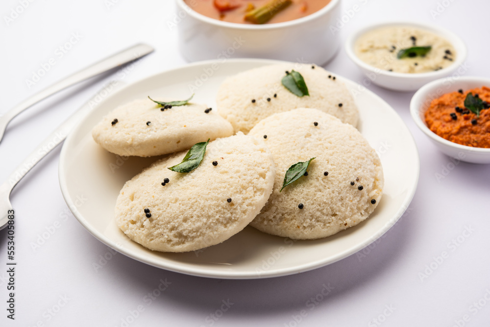Idly sambar or Idli with Sambhar and green, red chutney. Popular South indian breakfast Idly sambar or Idli with Sambhar and green, red chutney. Popular South indian breakfast