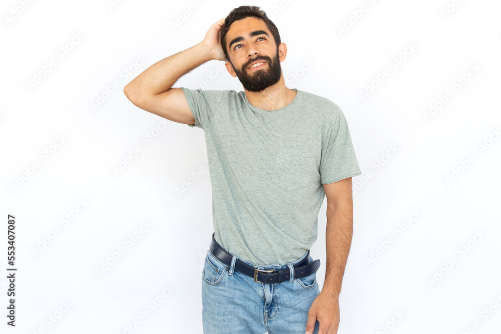 Pensive man scratching head. Young male model thinking hard. Portrait, studio shot, thoughtfulness concept Pensive man scratching head. Young male model thinking hard. Portrait, studio shot, thoughtfulness concept