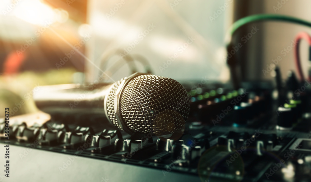 Obraz premium Close-up microphone and sound mixer in studio for sound record control system and audio equipment and music instrument. high quality dynamic microphone connect with male xlr connector.