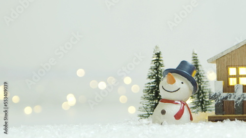 Merry Christmas background with snow, colorful bokeh backdrop.