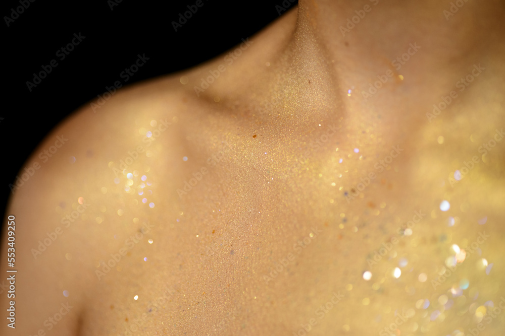 Fototapeta premium Closeup human skin with golden makeup. Selected focus with depth of field.