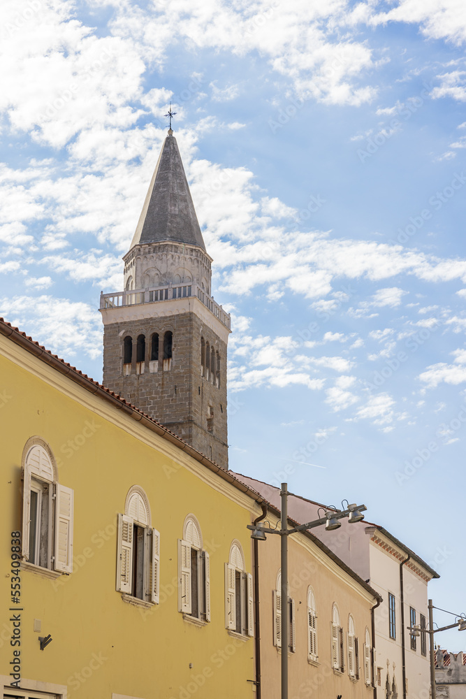 The cathedral tower of Koper stanfing tall above the small town