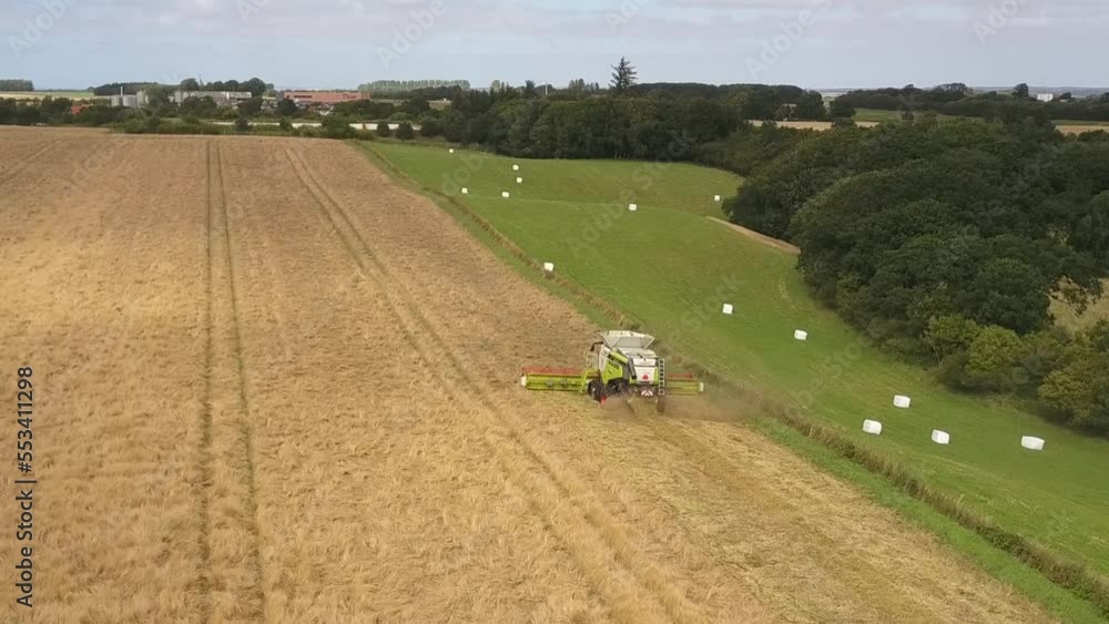 Aerial View of Combine Harvester Working on Grass Field Aerial View of Combine Harvester Working on Grass Field