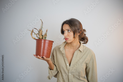 Dead Plant Woman Holding Pot with a Dead Dehydrated Plant with Brown Leaves Feeling Frustrated