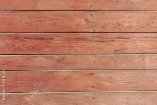 A hardwood aged wall background. Wooden red planks, a texture of a natural tree.