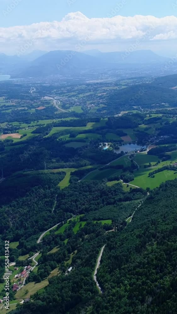 Vertical video of Aerial shot of green countryside, villages, forest and a lake Vertical video of Aerial shot of green countryside, villages, forest and a lake
