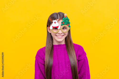 happy kid in party glasses on yellow background, xmas