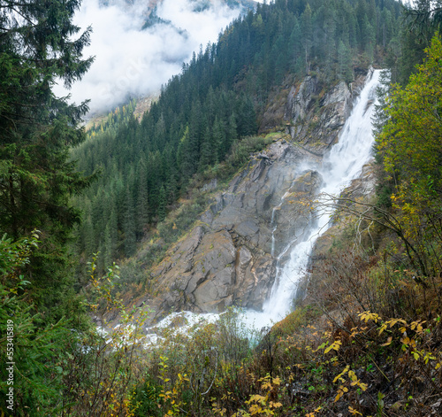 Krimml Waterfalls, Krimmler Wasserfalle,in High Tauern National Park, Austria. Krimmler Ache river falls. Beautiful dramatic waterfall on a misty rainy day. Hiking in Austrian Alps.