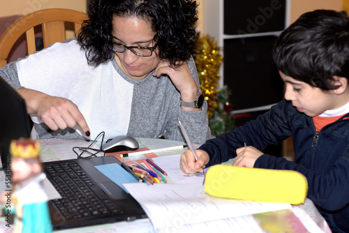 photograph of a young mother doing homework with her child. selective focus